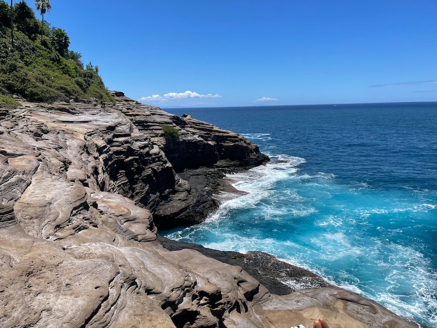 The Spitting Caves of Portlock are a geological formation in Oahu, Hawaii. Ocean water rushes into a cave and then is pushed back out, making a "spitting" sound.
