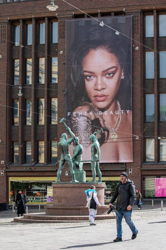advertising Fenty Beauty cosmetic brand with image of Rihanna on Stockmann department store wall in Helsinki, Finland
